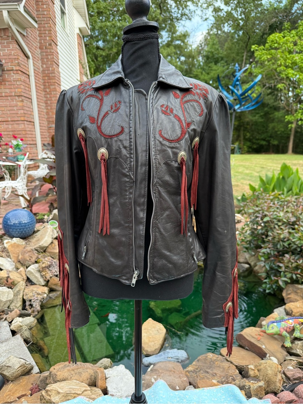 Black Vintage Motorcycle Leather Fringe Jacket with Red suede embossed detail.
